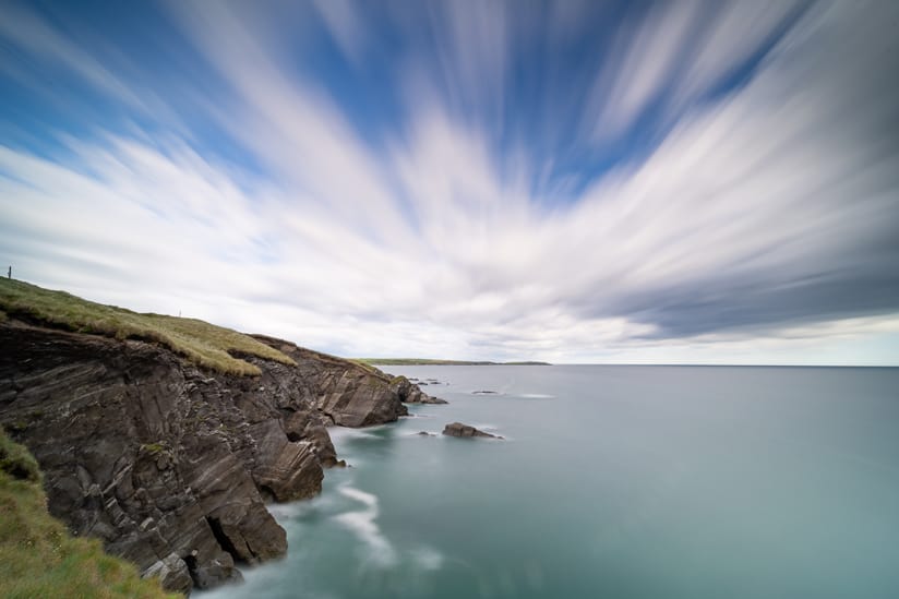 Clouds drifting over cliffs and the ocean in West Cork, Ireland