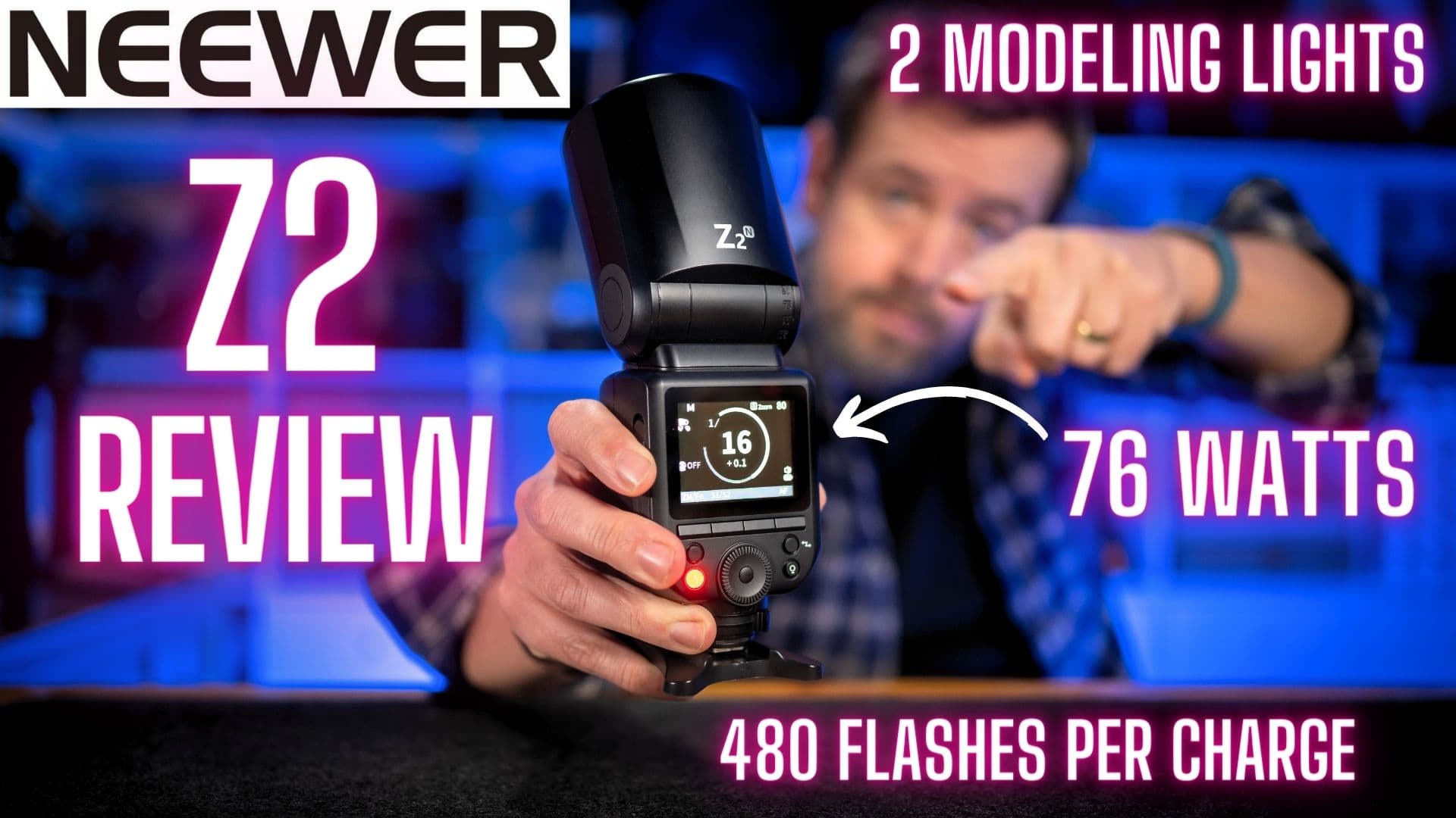 Man pointing at the Neewer Z2 Flash for my Neewer Z2 Review video