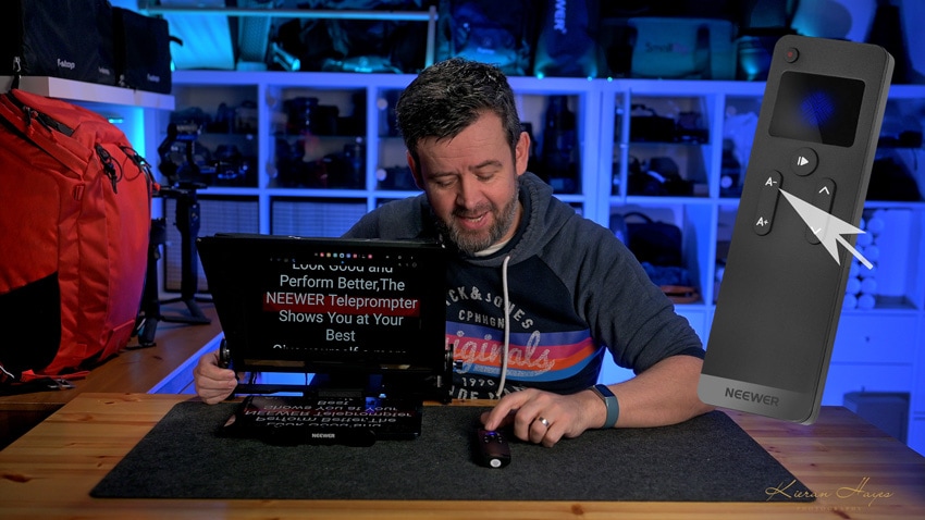 A man setting up the Neewer X17 ii teleprompter in a studio