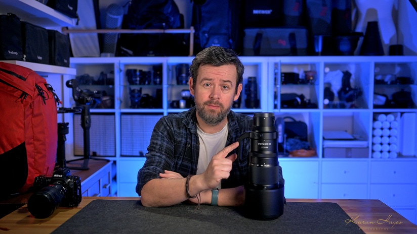 A man pointing at the Nikon Z 180-600mm lens