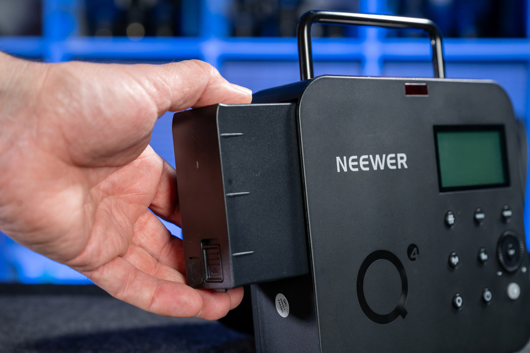 Inserting the battery into the Neewer Q4 strobe