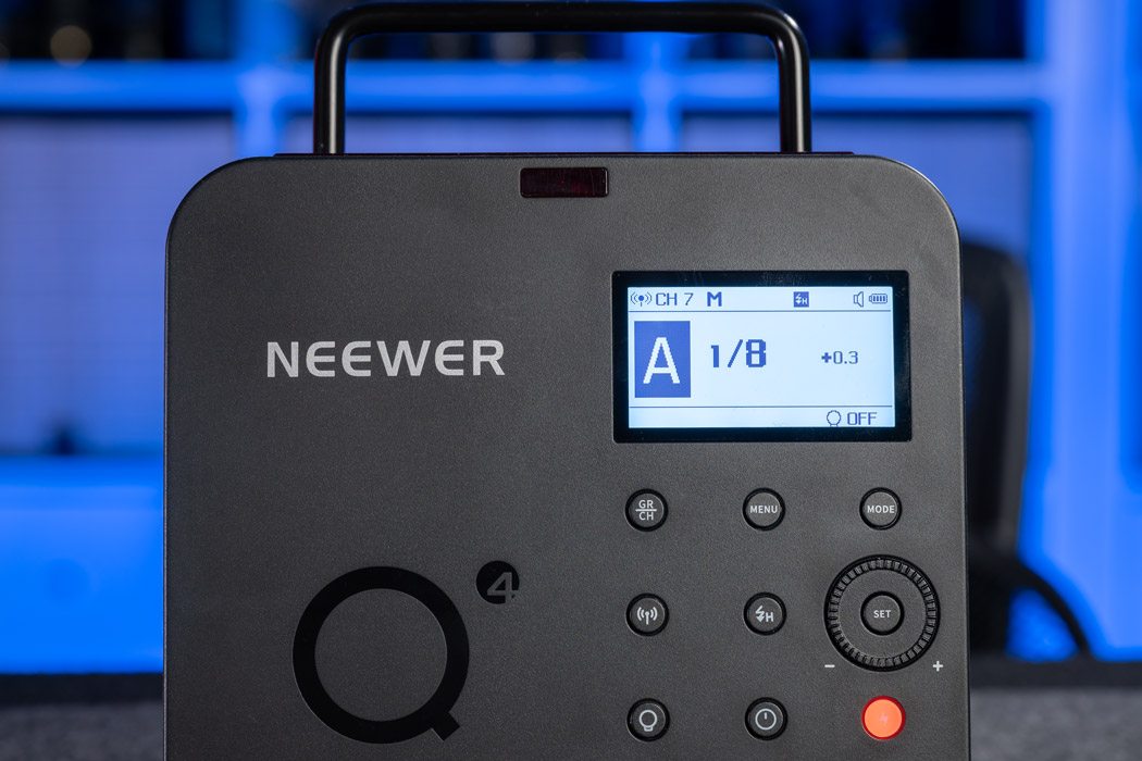 A closeup of the Neewer q4 display and back button controls.