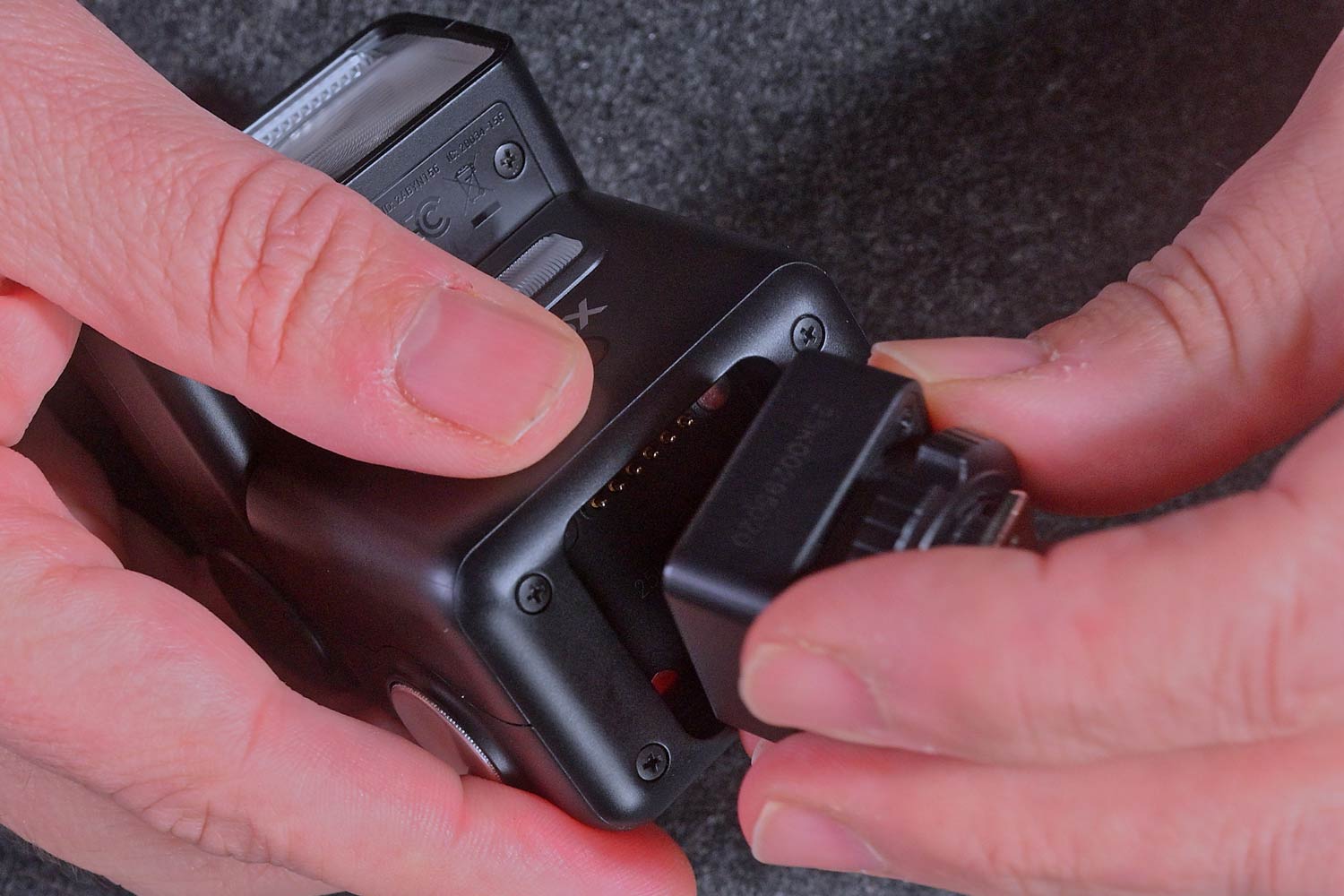 The Godox IT32 with the Godox X5 transmitter being slotted into place.