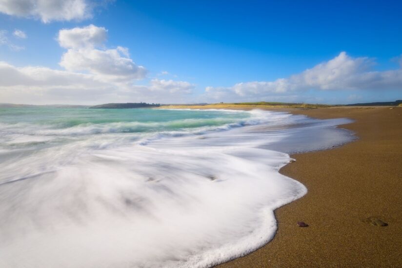 Photography Workshops Ireland with a photograph of Long Strand Beach taken mid day.
